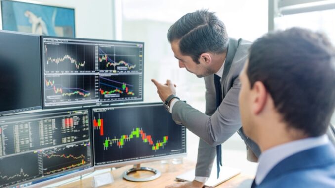 Trader analyzing complex technical indicators during volatile market conditions.